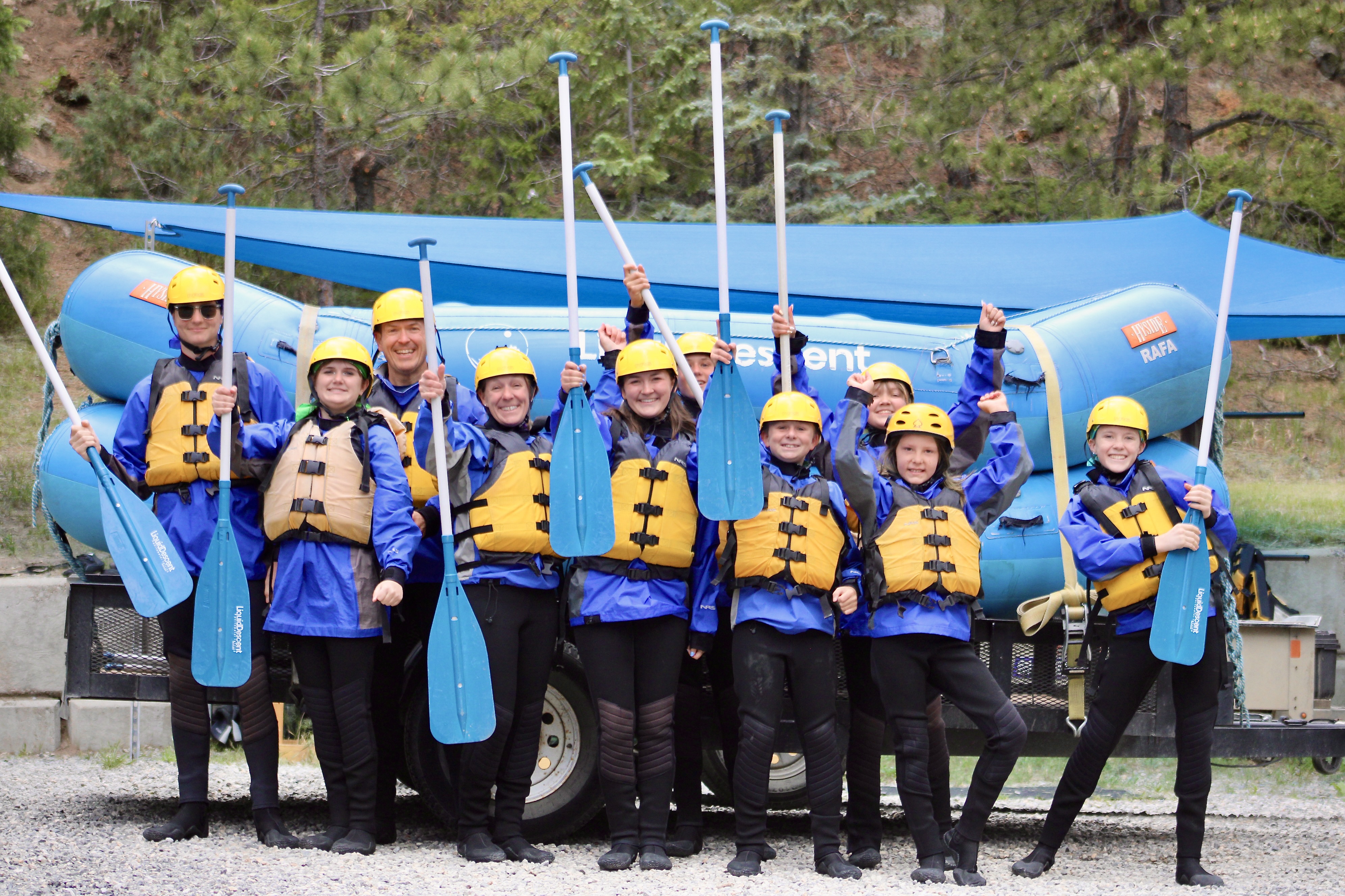 Smiling group ready to raft with Liquid Descent